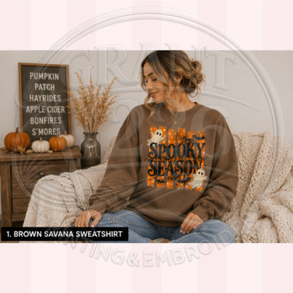 Woman wearing Brown Savana Spooky Season Halloween sweatshirt with retro ghosts and orange graphic