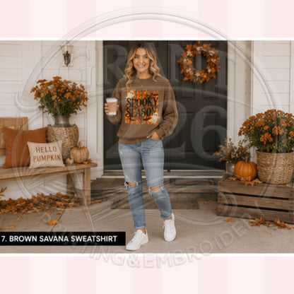 Woman wearing Brown Savana retro ghost Halloween crewneck on a fall decorated porch
