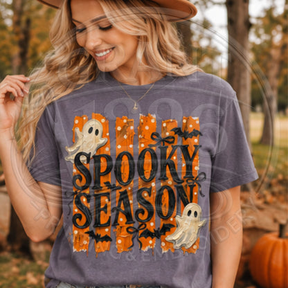 Woman wearing Grape Comfort Colors Spooky Season Halloween T-shirt with retro orange ghost graphic