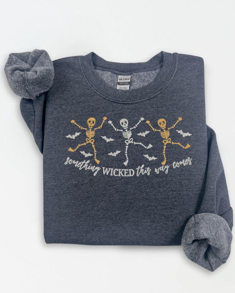 Front view of spooky skeleton embroidered Halloween sweatshirt with dancing skeleton design
