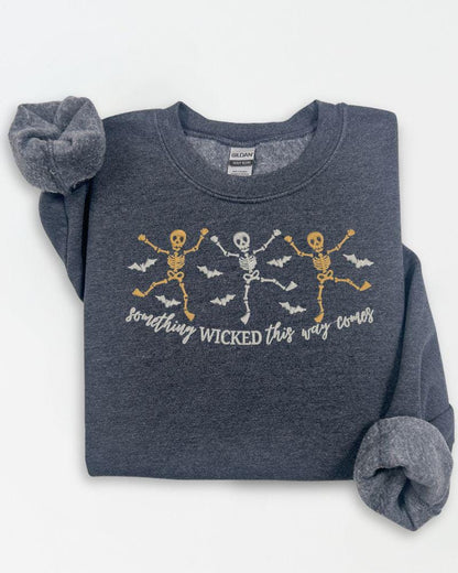 Front view of spooky skeleton embroidered Halloween sweatshirt with dancing skeleton design
