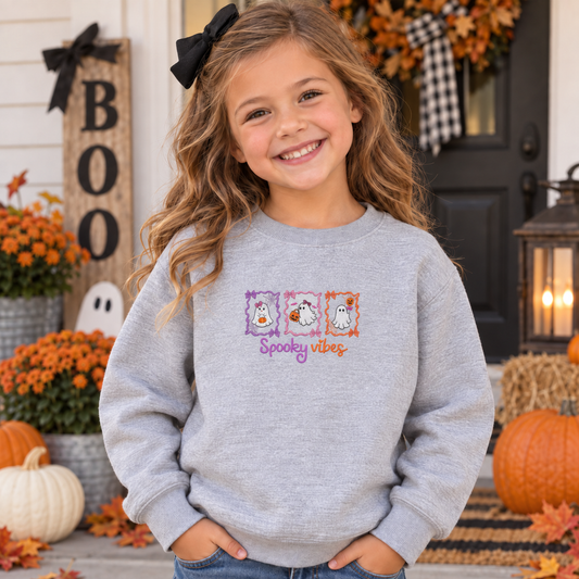 Youth wearing Sport Grey Spooky Vibes embroidered Halloween sweatshirt
