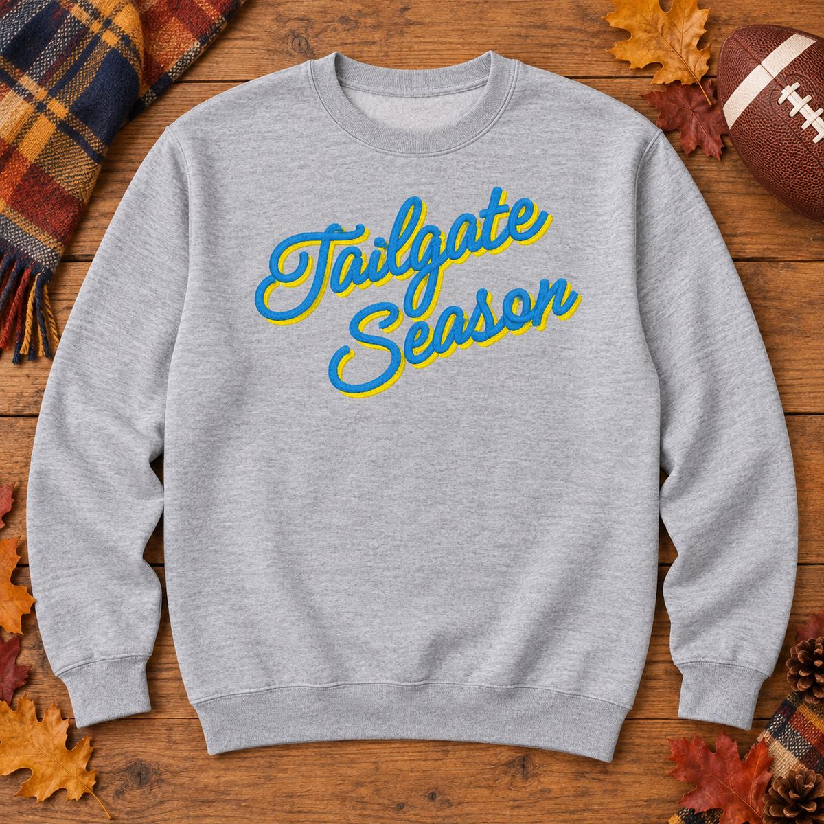 Sport Grey Tailgate Season embroidered sweatshirt flat lay with football and fall tailgate accents