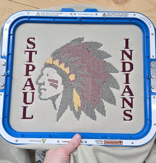Full St. Paul Indians mascot embroidery in maroon, gold, black, and white on a sand sweatshirt