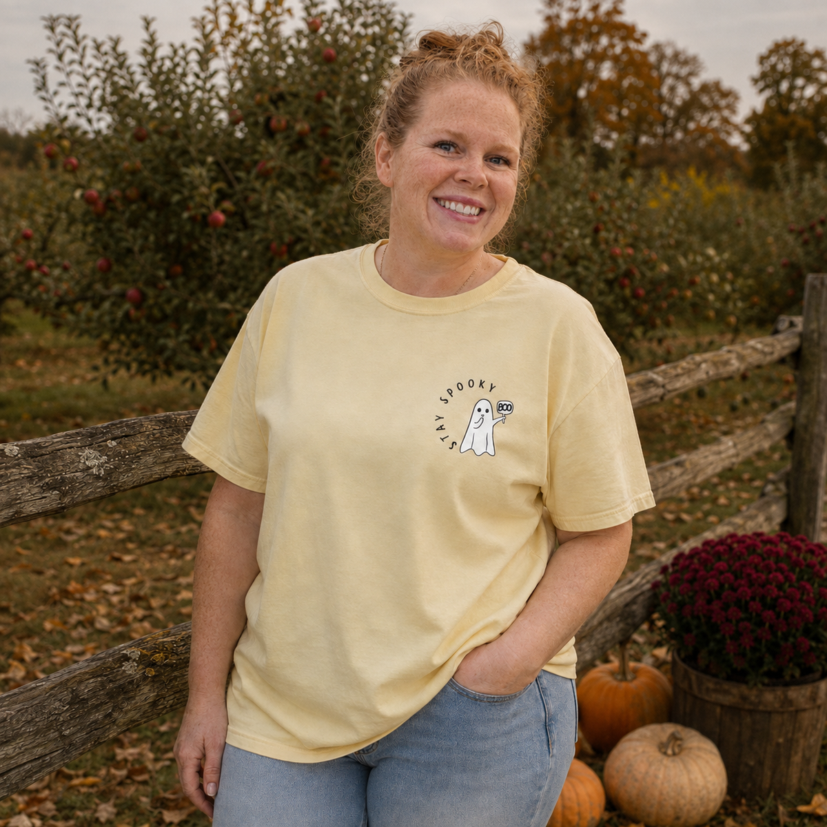 Stay Spooky ghost embroidered Comfort Colors 1717 Butter T-shirt modeled by Samantha at a fall apple orchard