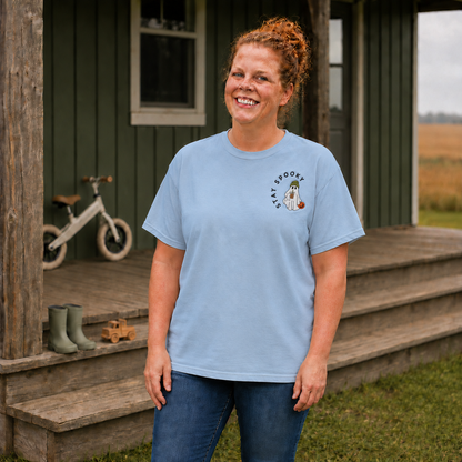 Woman wearing a Chambray Comfort Colors shirt with Stay Spooky coffee ghost embroidery on the left chest