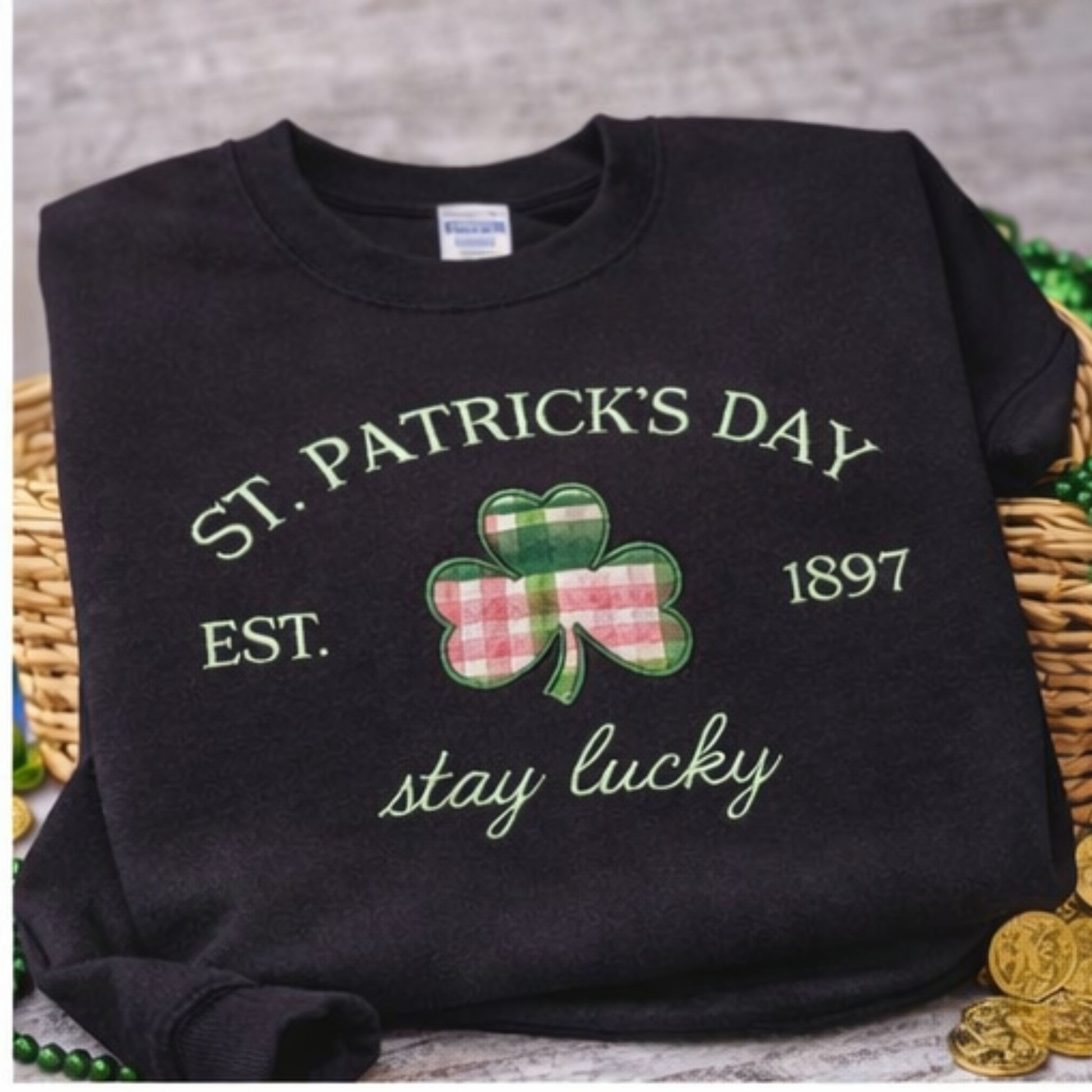 Black St. Patrick's Day shirt with a shamrock design and text on a textured surface.