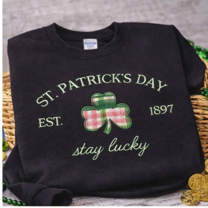 Black St. Patrick's Day shirt with a shamrock design and text on a textured surface.