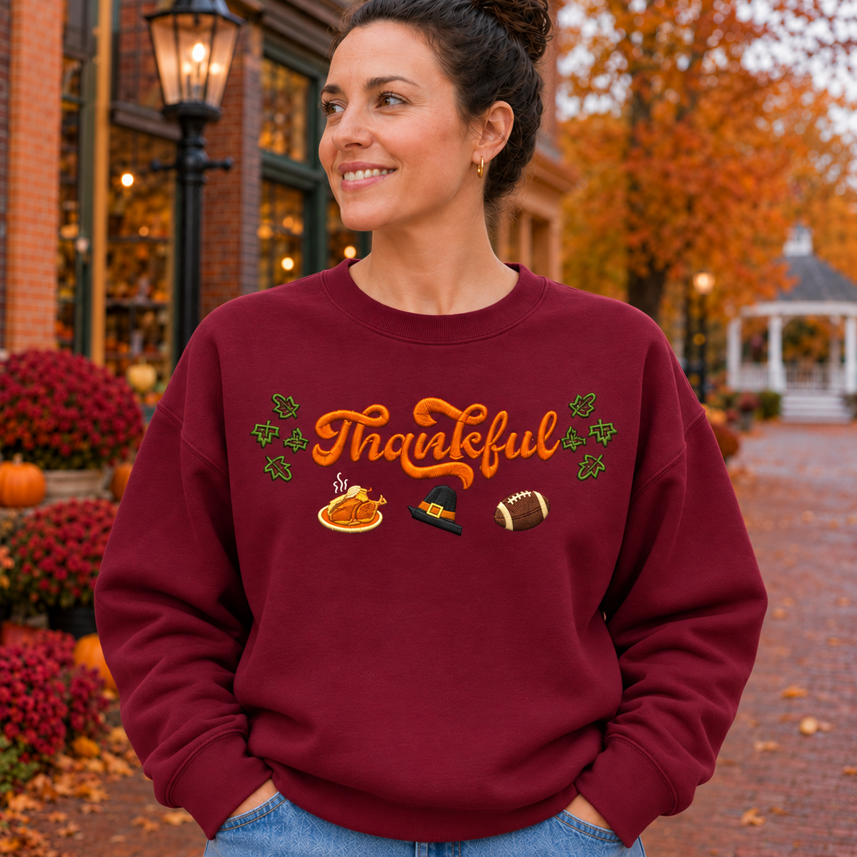 Close embroidery detail of fall Thankful design on maroon Gildan Softstyle sweatshirt