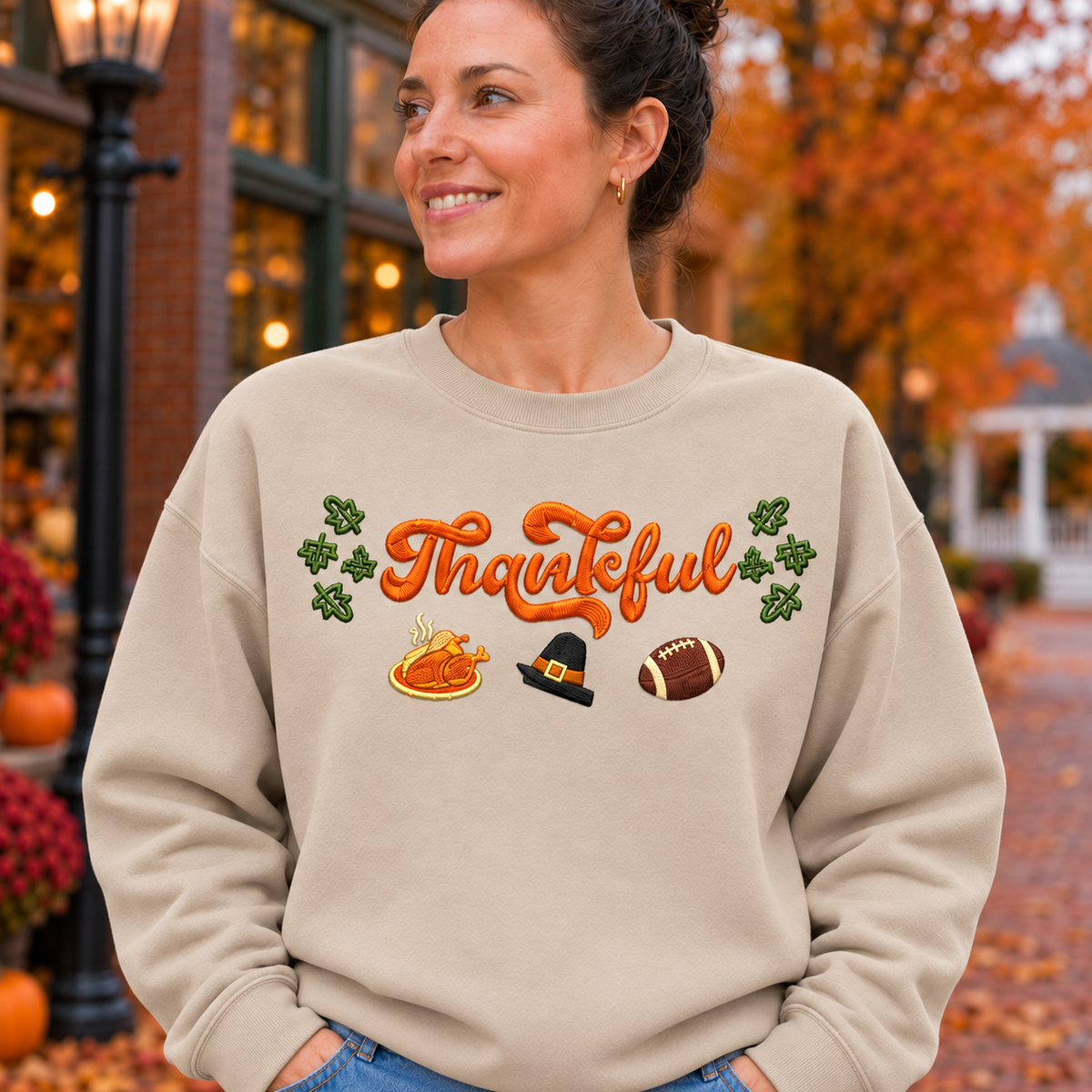 Close embroidery detail of fall Thankful design on sand Gildan Softstyle sweatshirt