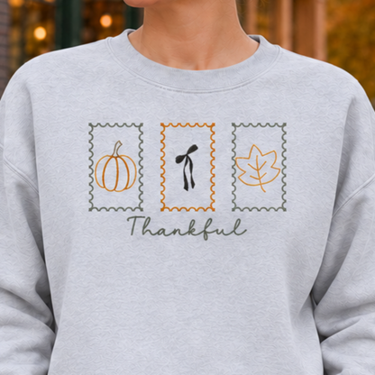 Ash sweatshirt chest detail with Thankful Stamps embroidery