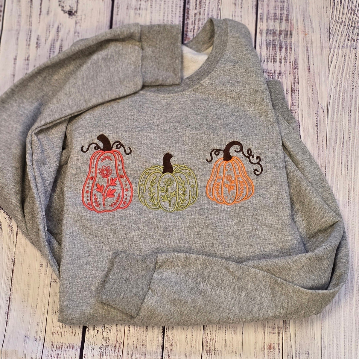 Sport Grey Gildan Softstyle fall sweatshirt embroidered with three floral line-art pumpkins