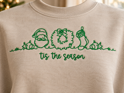 Close detail of Tis The Season green thread embroidery on Sand sweatshirt