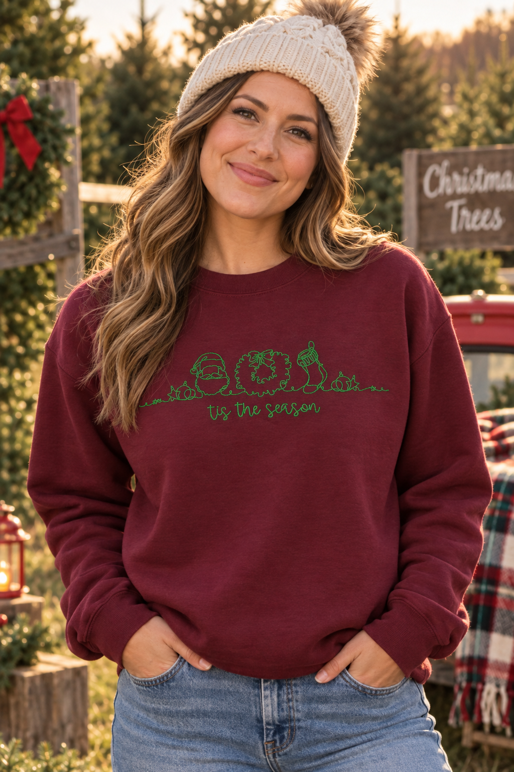 Woman wearing Maroon Tis The Season embroidered holiday crewneck at a Christmas tree farm