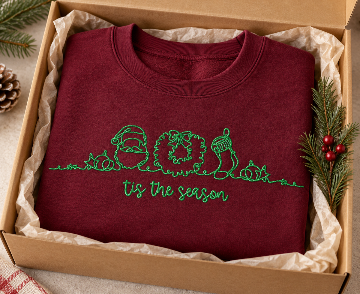 Maroon Tis The Season embroidered sweatshirt shown gift ready in a kraft box