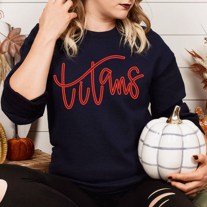 Model wearing navy Titans script embroidered sweatshirt with fall pumpkins