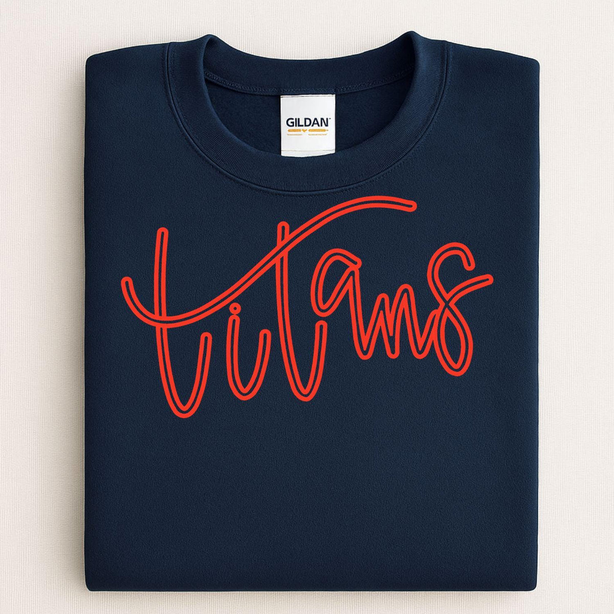 Folded navy crewneck with red Titans script puff embroidery
