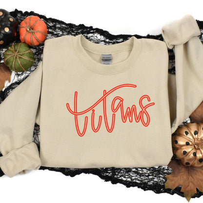Sand Titans embroidered sweatshirt styled in an autumn flat lay