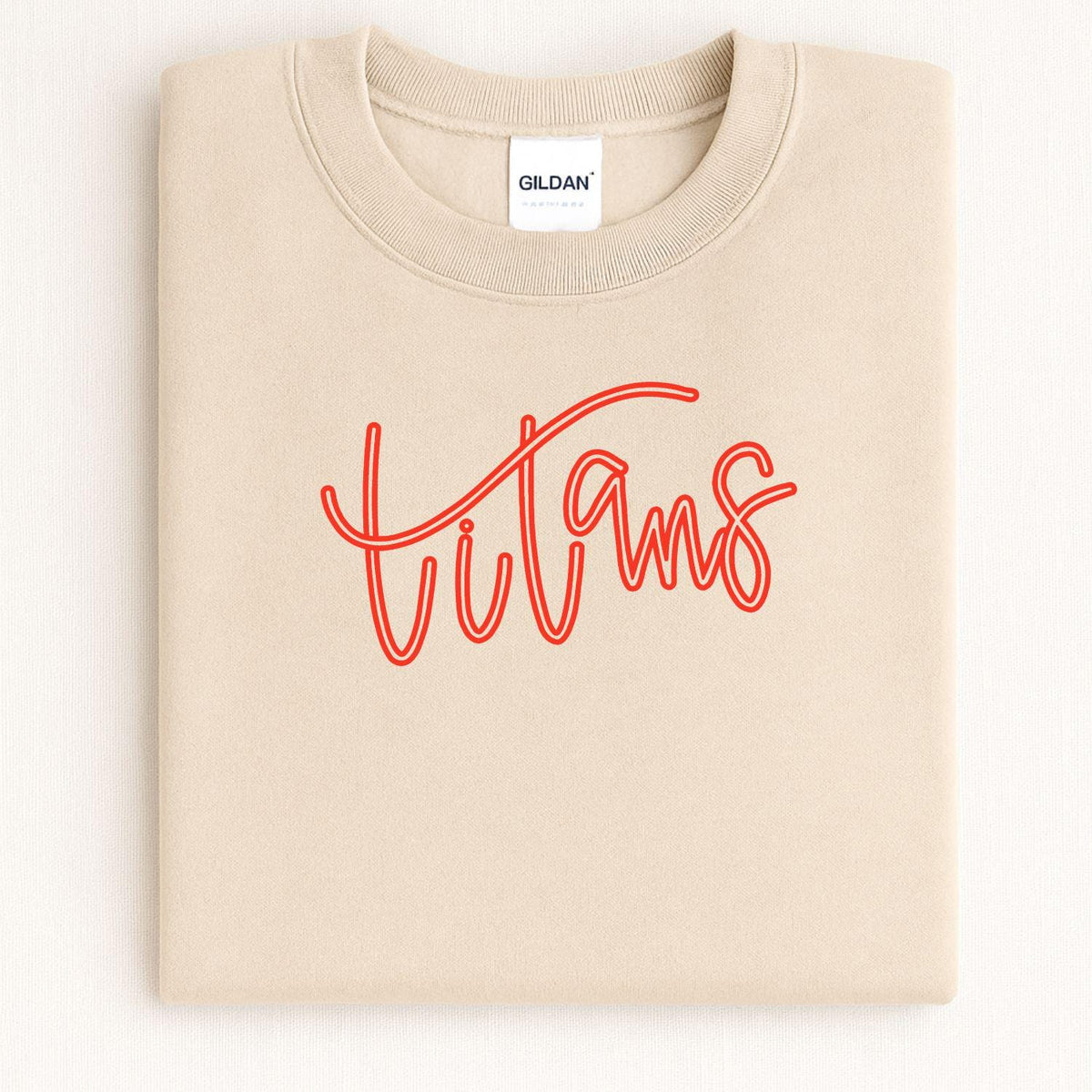Folded sand crewneck with red Titans script embroidery