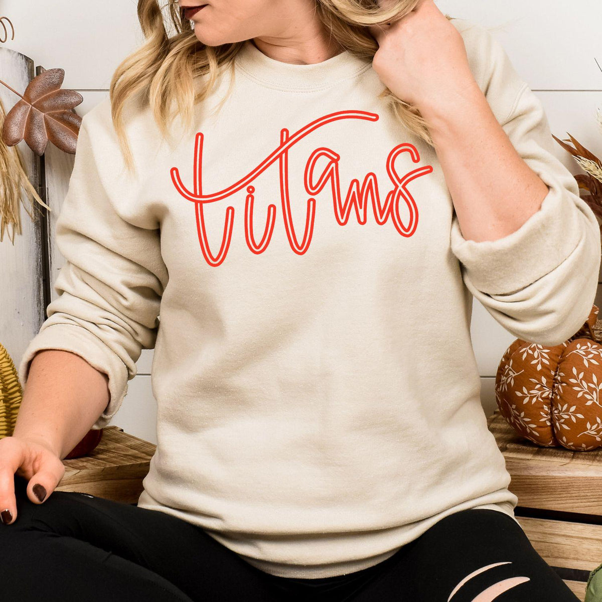 Model wearing sand Titans script embroidered team sweatshirt