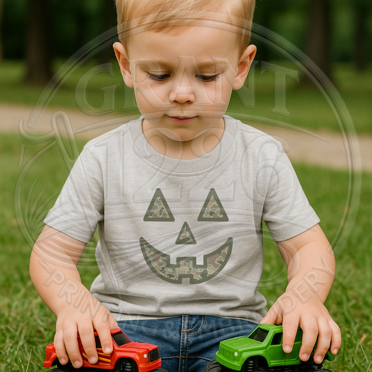 Toddler wearing Sport Grey camouflage pumpkin Halloween shirt while playing