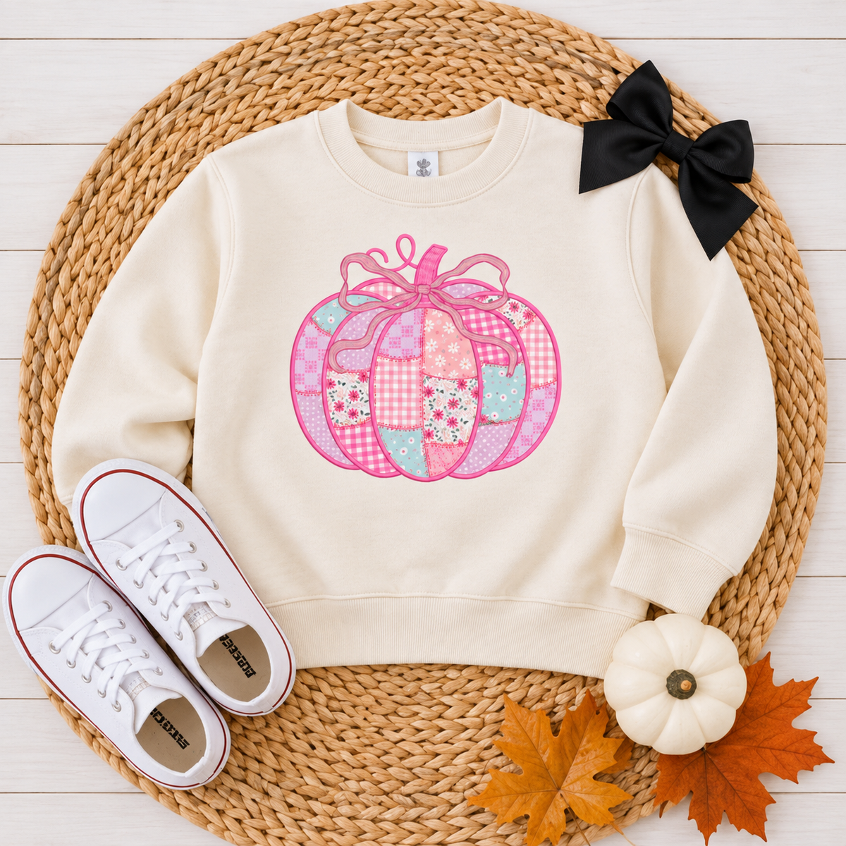 Natural Rabbit Skins toddler sweatshirt with a pink patchwork bow pumpkin DTG design