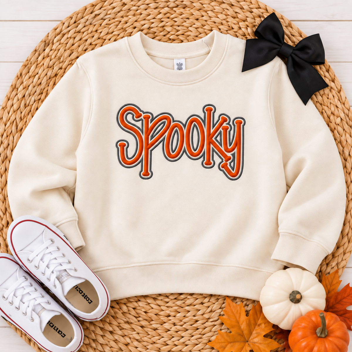 Natural toddler sweatshirt with orange and charcoal Spooky puff embroidery in a Halloween flat lay