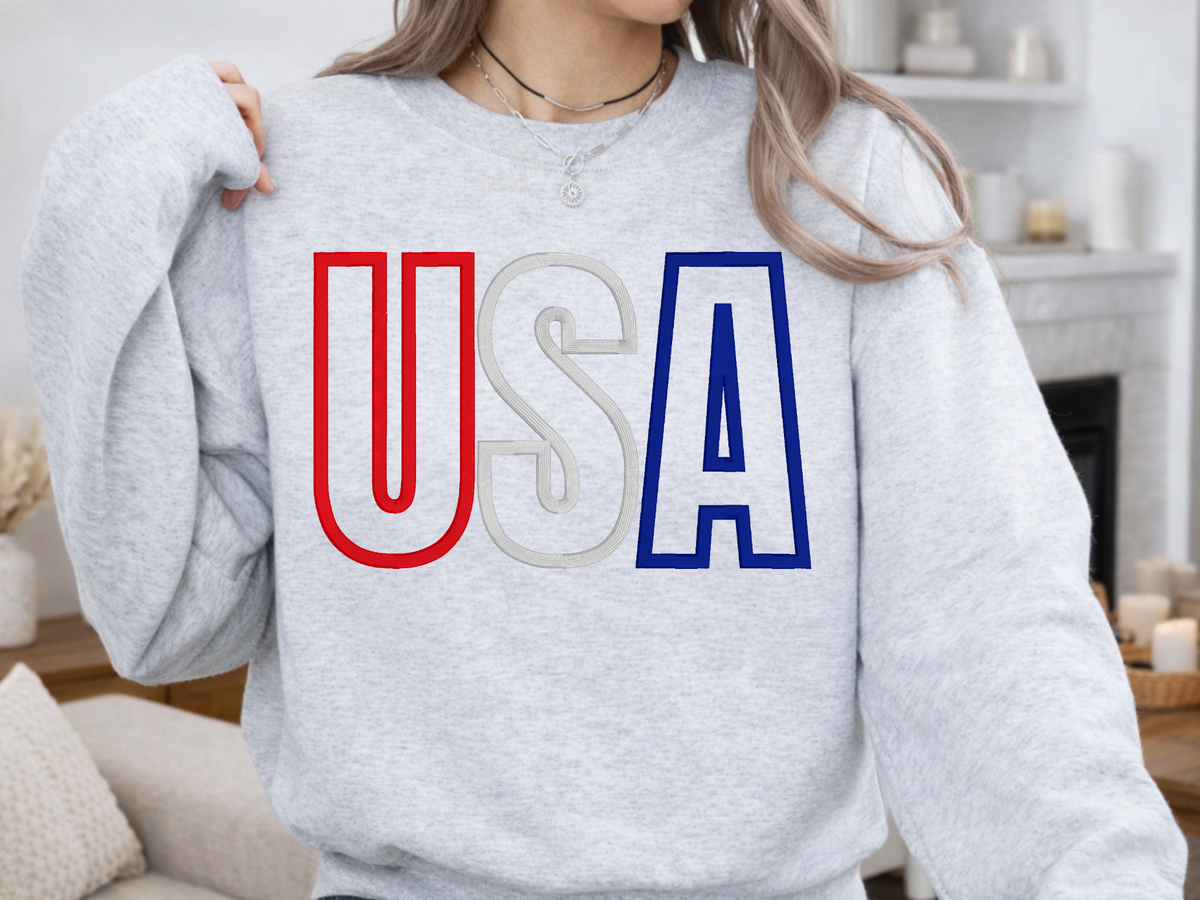 Ash Gildan crewneck sweatshirt with raised USA embroidery in red, white, and blue