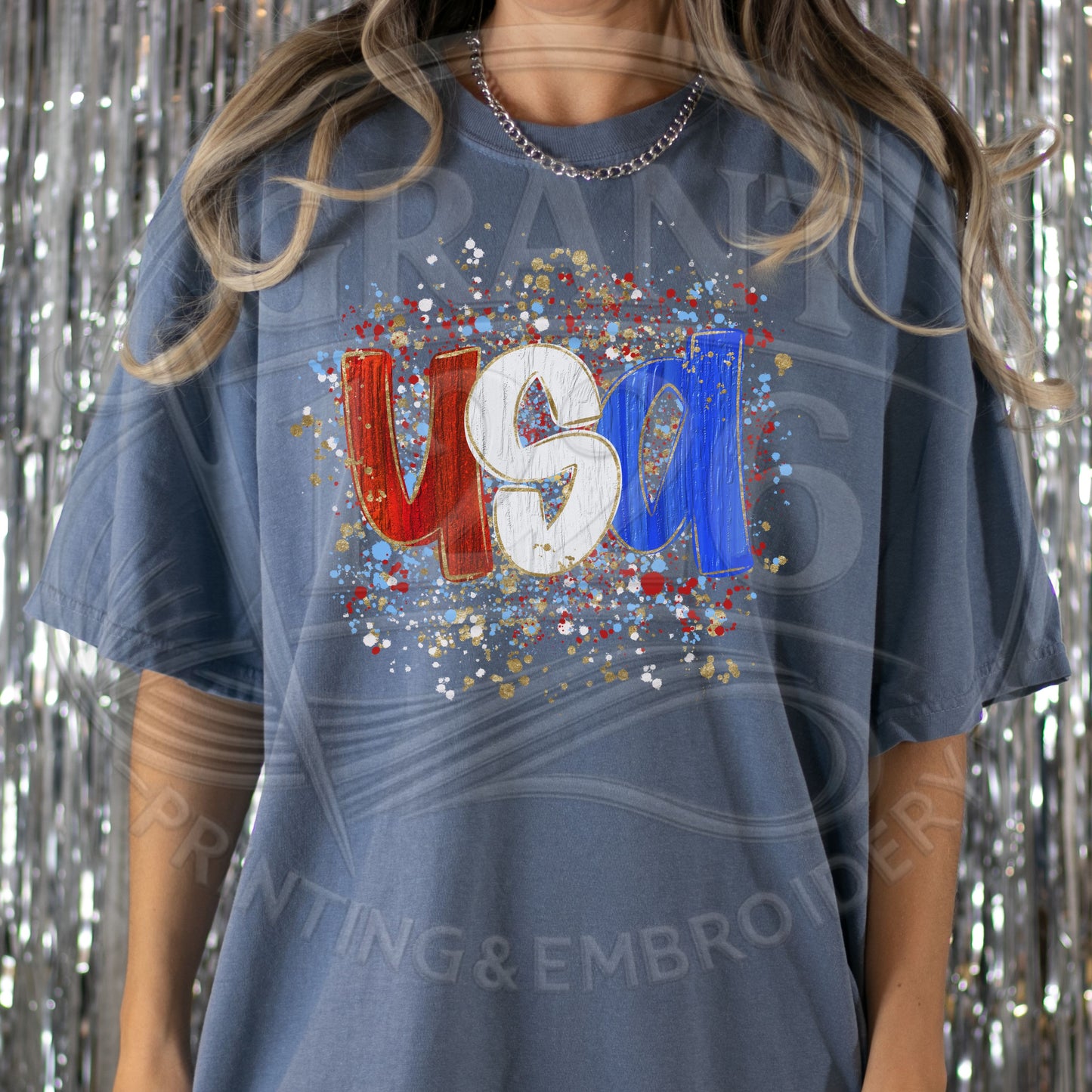 Woman wearing trendy USA patriotic graphic tee with red white and blue splatter design