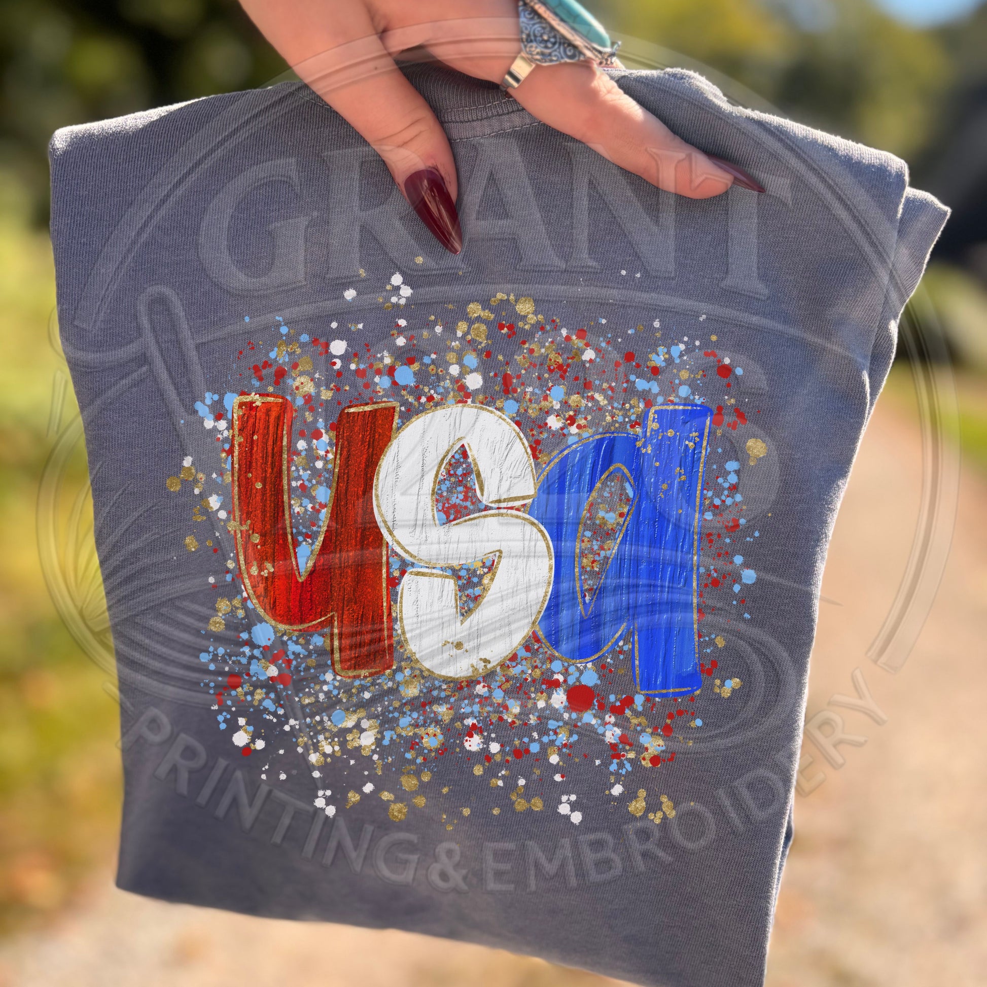 blue jean USA patriotic graphic shirt with trendy Americana splatter artwork