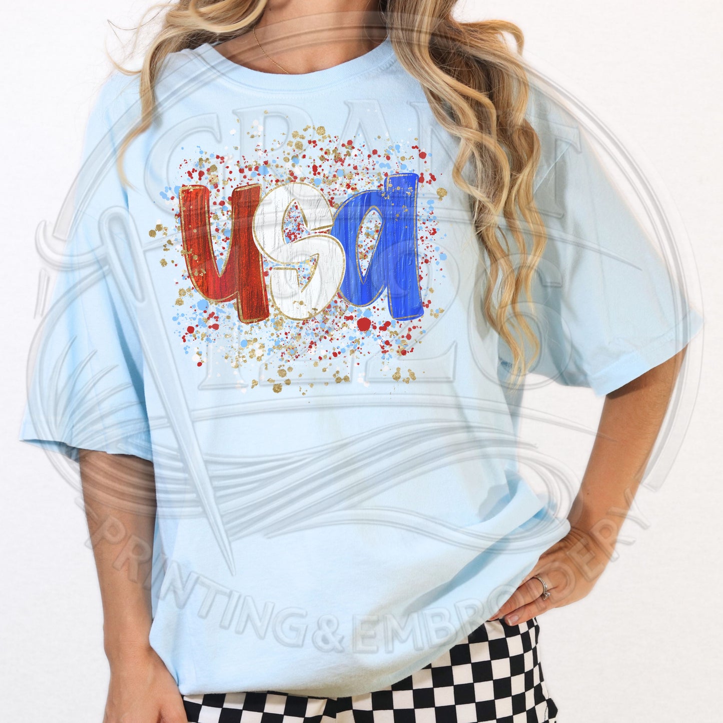Woman modeling light blue patriotic USA graphic shirt for Fourth of July outfit