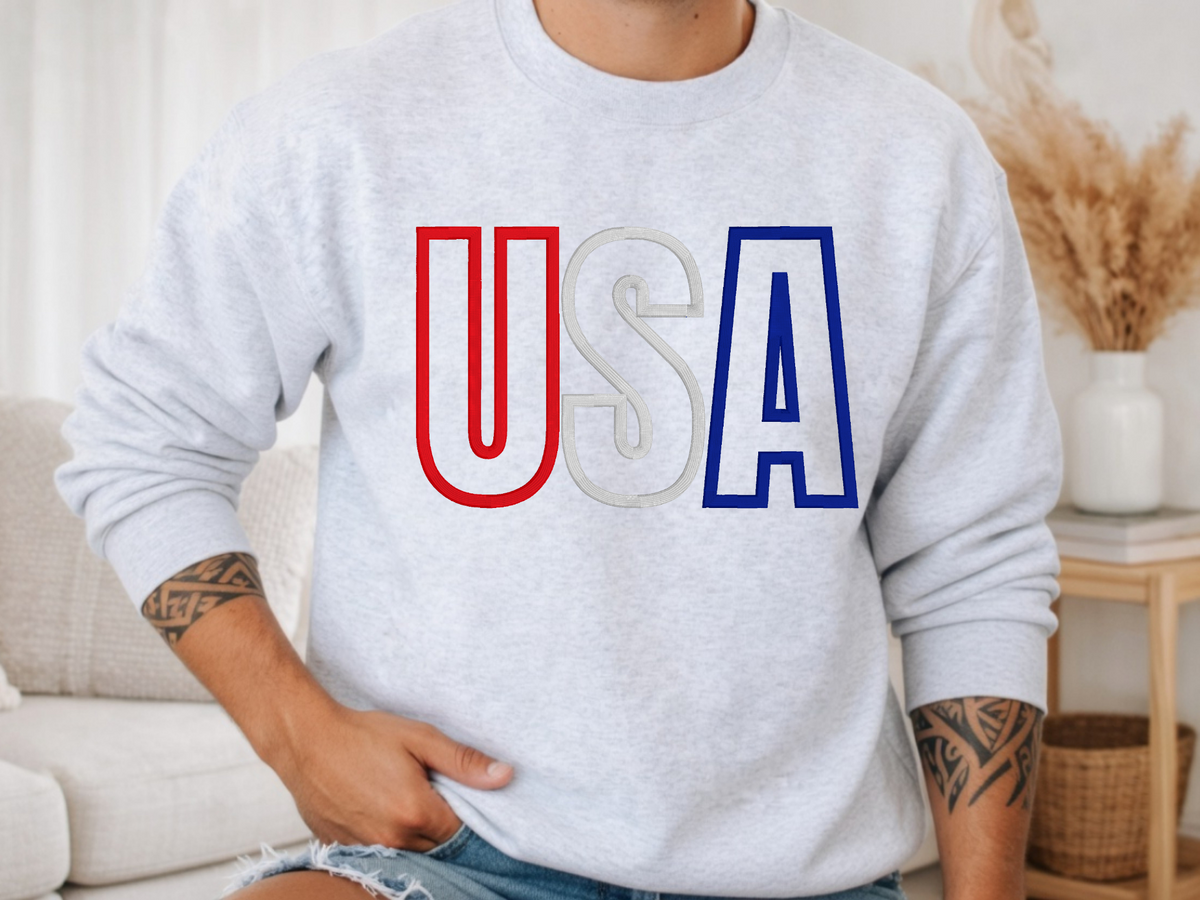 Ash crewneck sweatshirt showing the USA varsity-style puff embroidery