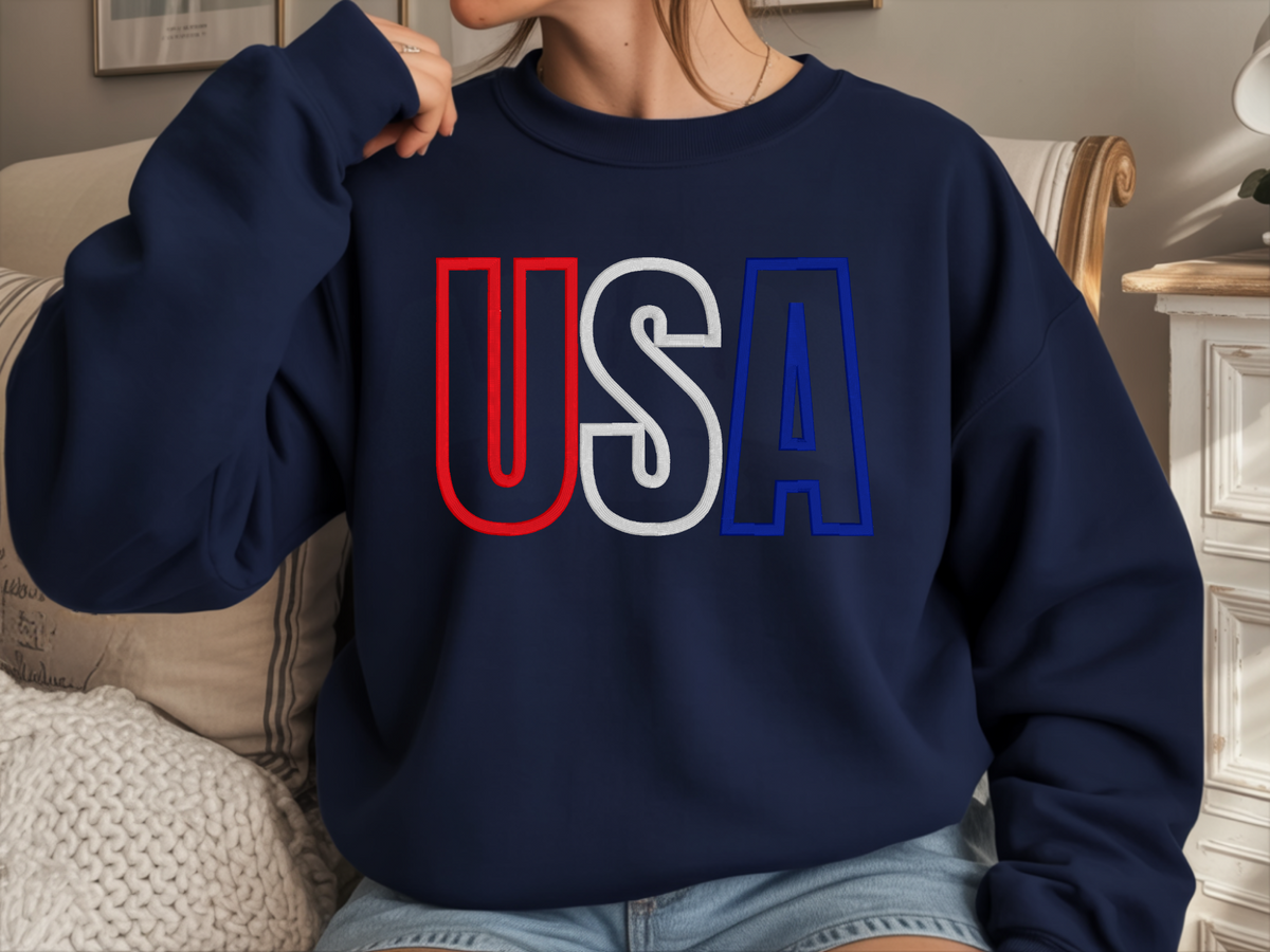 Navy crewneck sweatshirt showing the USA varsity-style puff embroidery