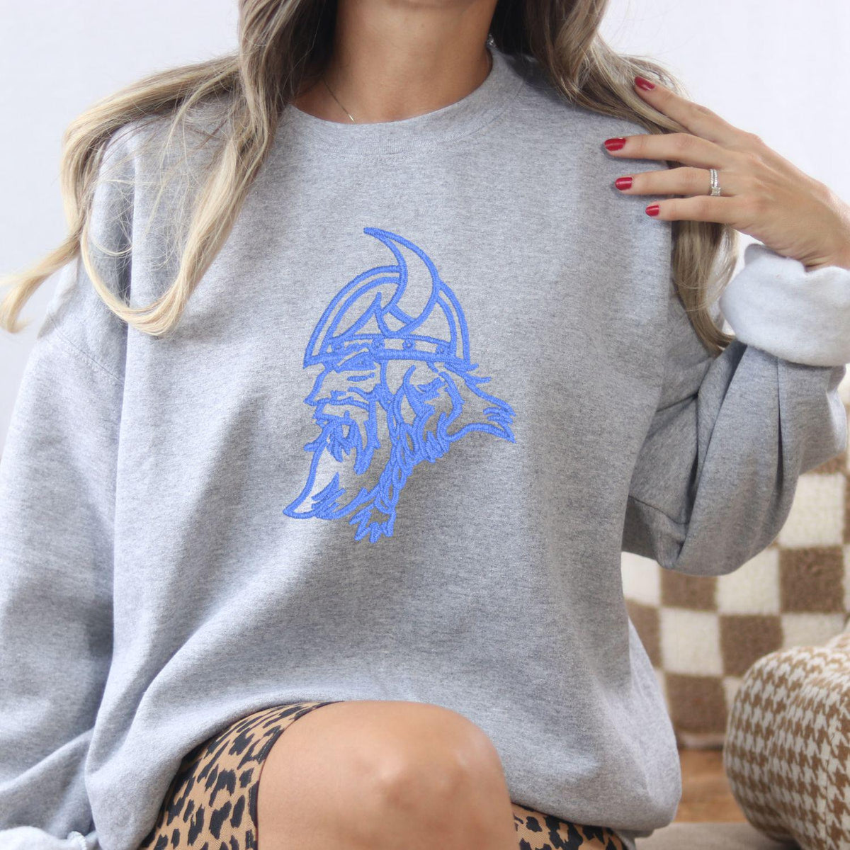 Sport gray vintage Viking mascot embroidered sweatshirt modeled indoors