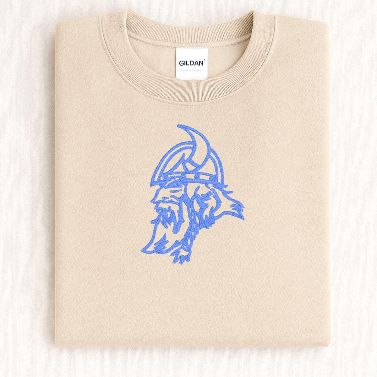 Sand Viking mascot embroidered crewneck folded on a light background