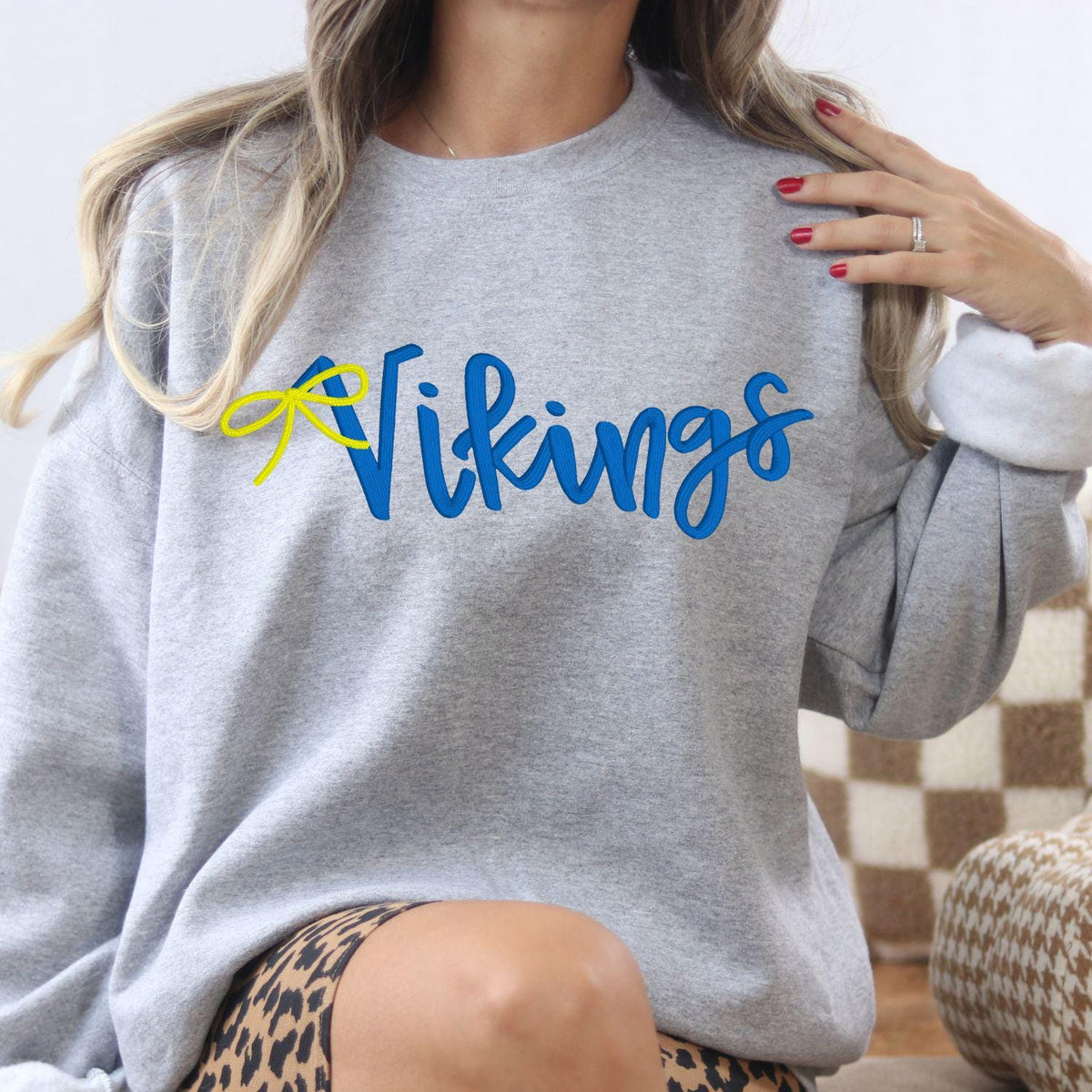 Sport gray Vikings script sweatshirt modeled indoors