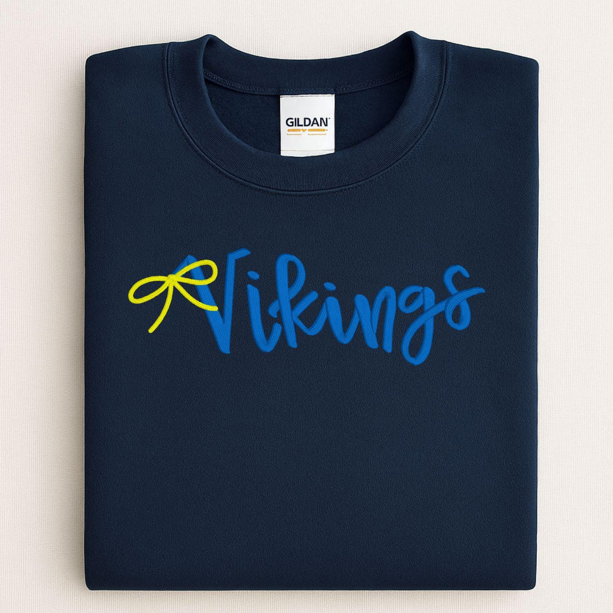 Navy Vikings script embroidered sweatshirt folded for a front view