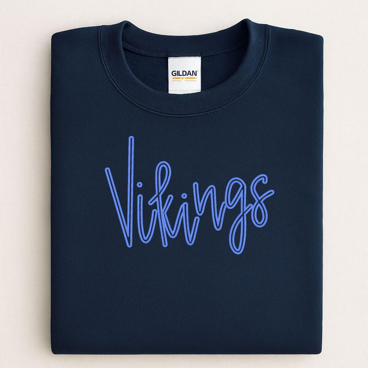 Folded navy crewneck with blue Vikings script puff embroidery