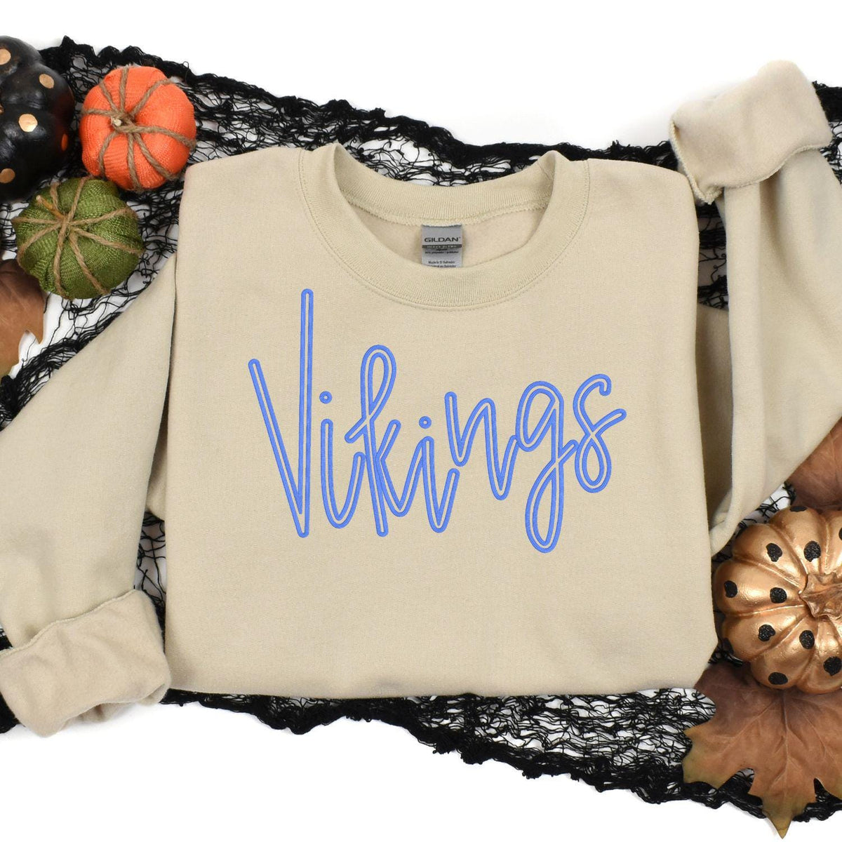 Sand Vikings embroidered sweatshirt styled in an autumn flat lay