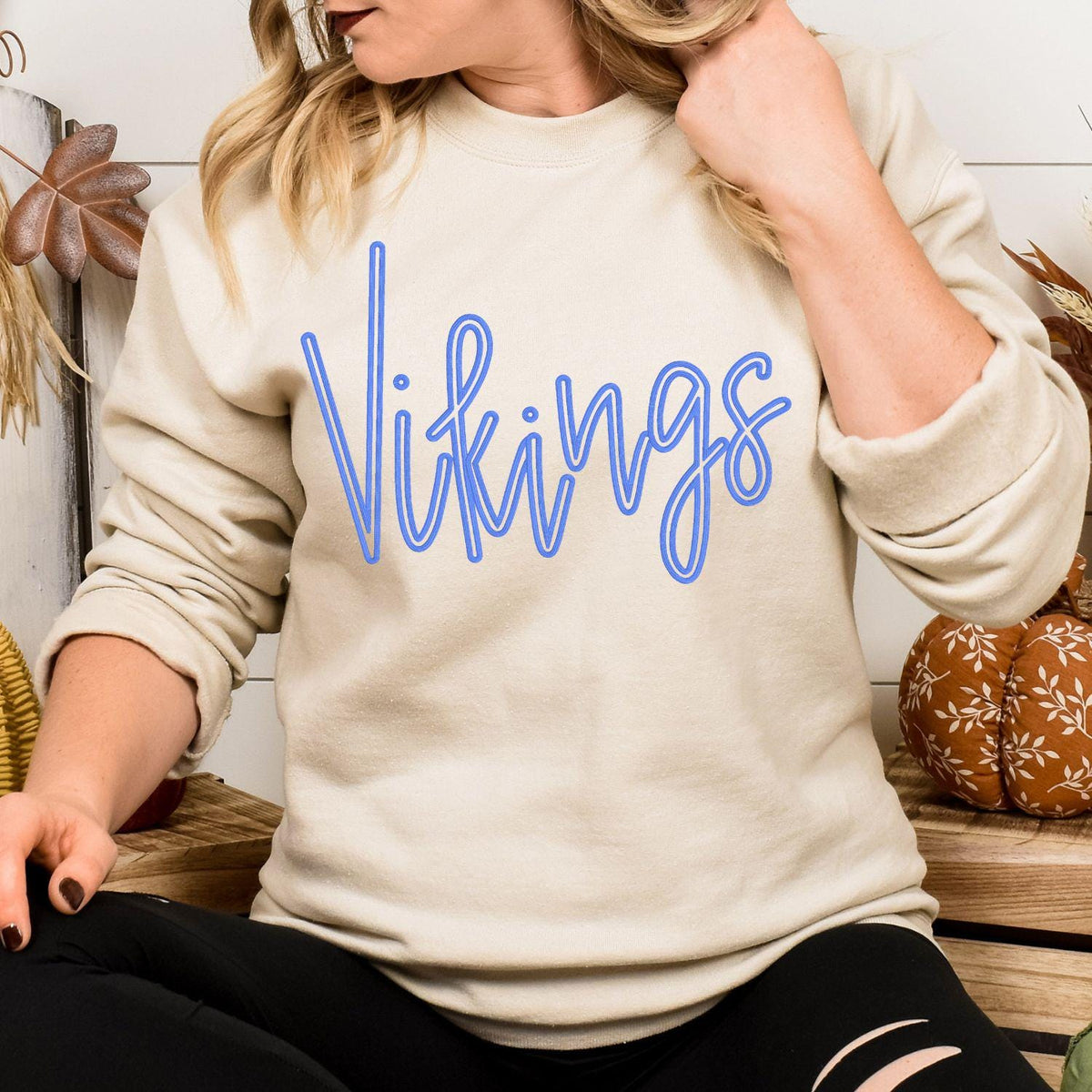 Model wearing sand Vikings script embroidered team sweatshirt