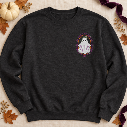 Heathered-black crewneck laid flat with a small framed ghost embroidery, cream pumpkin, fall leaves, and plum ribbon.