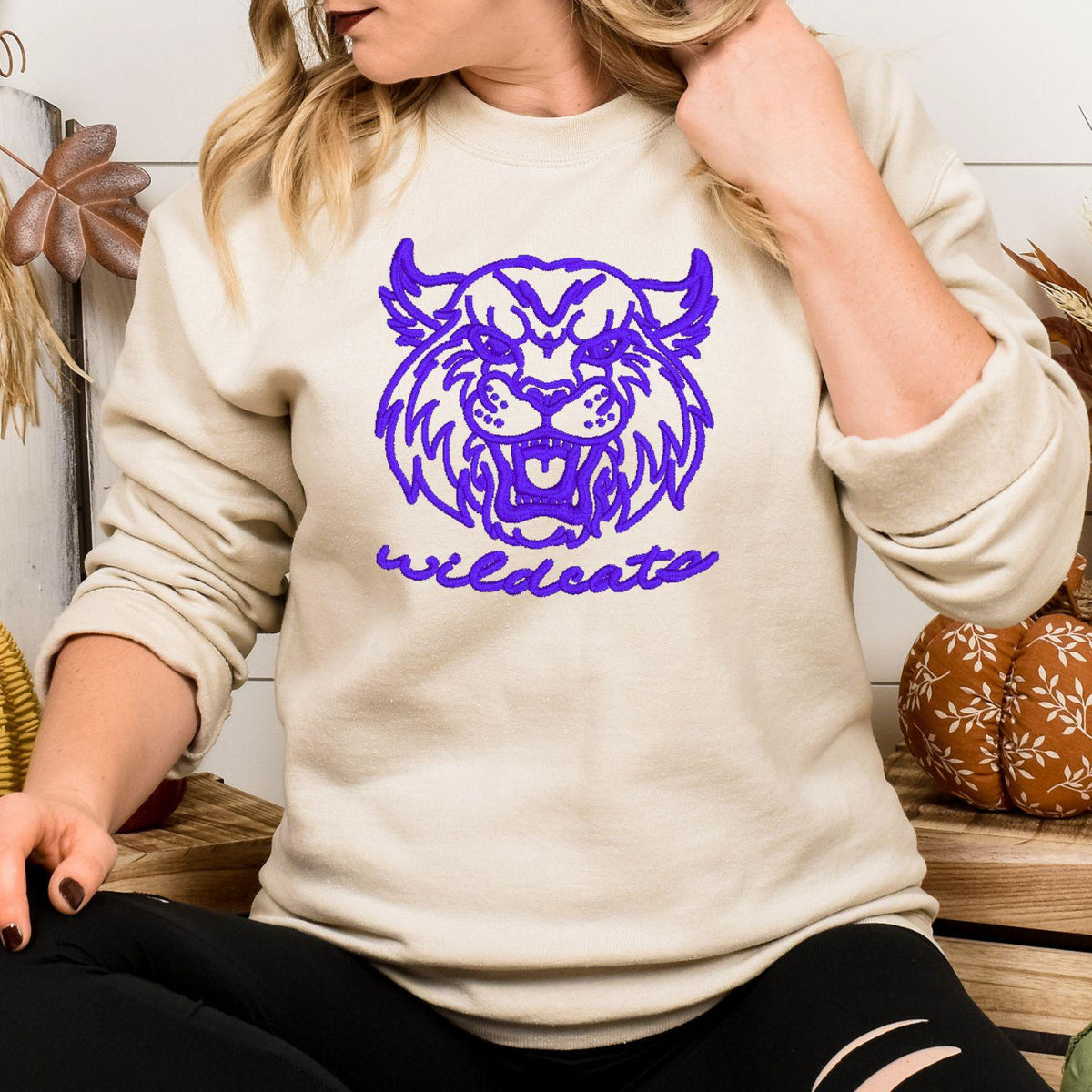 Sand vintage Wildcats mascot embroidered sweatshirt modeled indoors