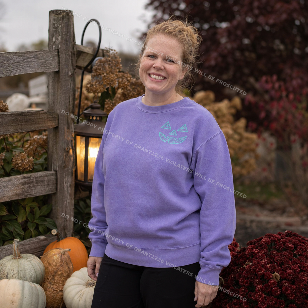 Violet embroidered pumpkin face sweatshirt styled at a rustic autumn pumpkin patch