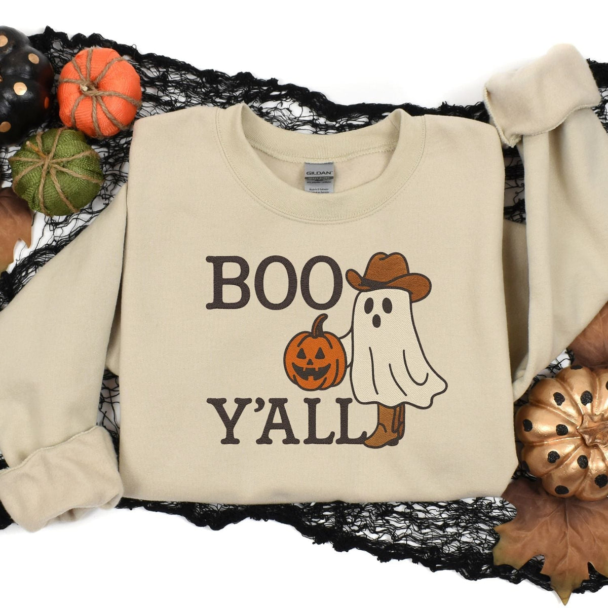 Sand western Halloween embroidered crewneck in a pumpkin flat lay