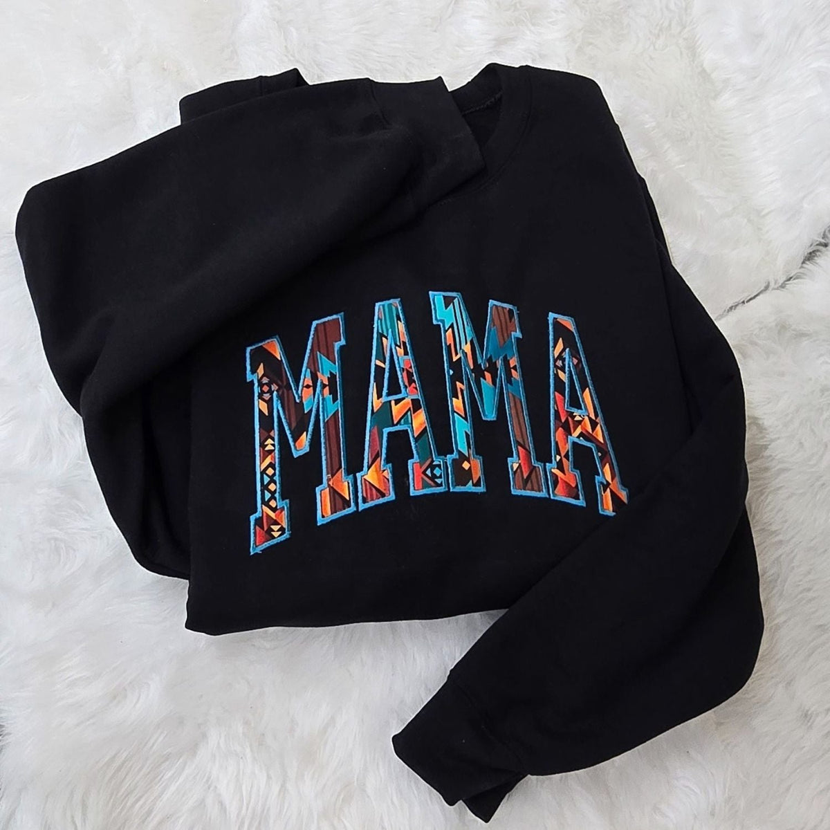 Black Gildan Heavy Blend sweatshirt with colorful Western geometric MAMA embroidery on white fur