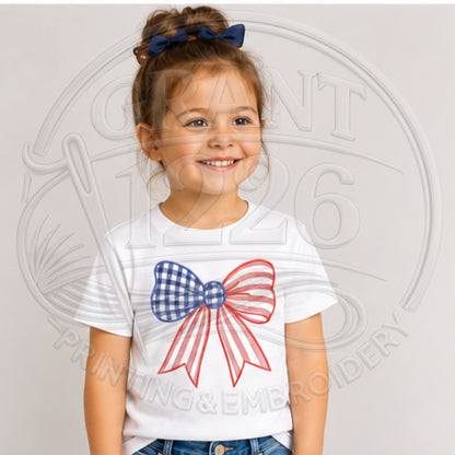 Child wearing White embroidered red, white, and blue gingham bow shirt