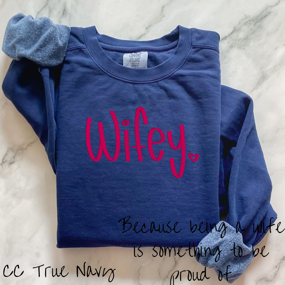 True navy Comfort Colors crewneck embroidered with a bright pink Wifey design