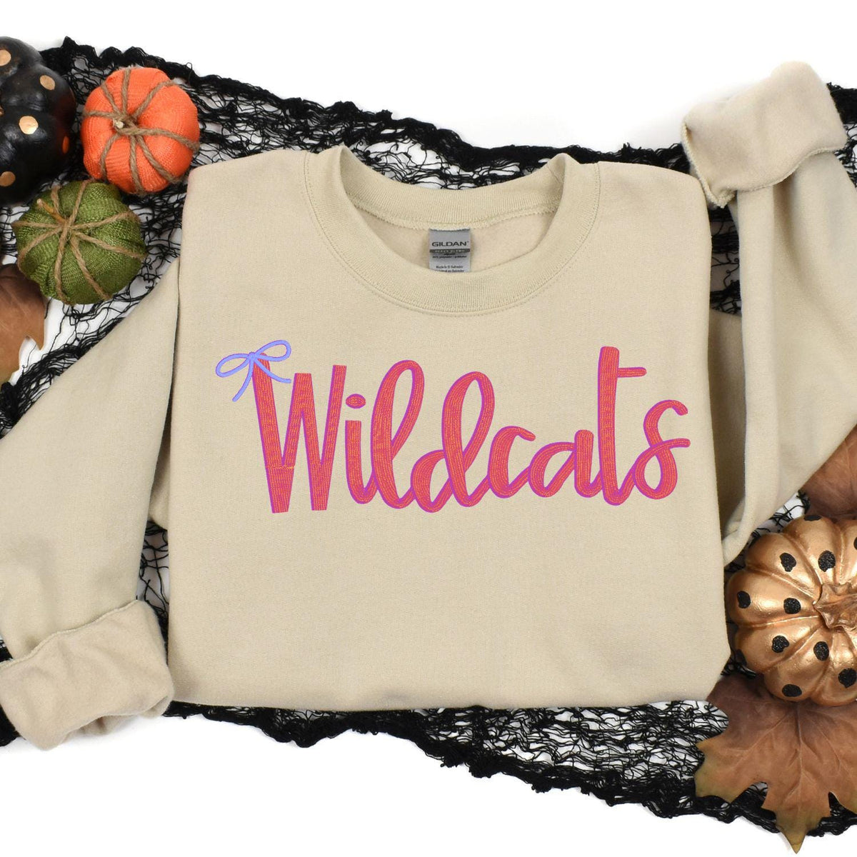 Sand Wildcats bow embroidered sweatshirt styled in an autumn flat lay