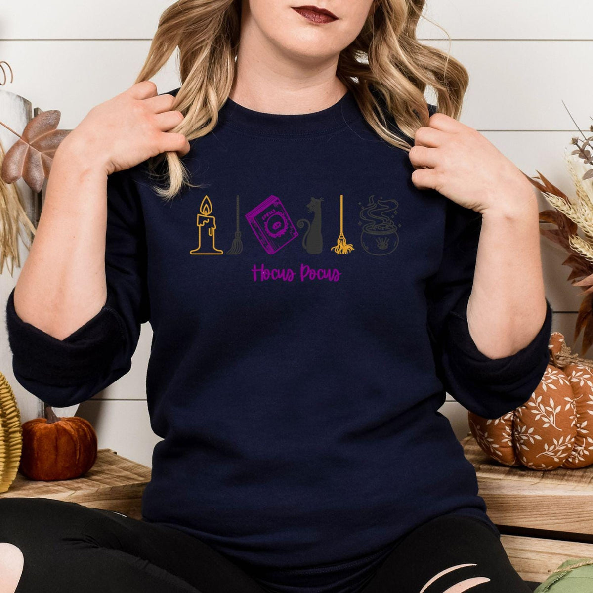 Navy Halloween crewneck with colorful witchy icon embroidery in a fall setting