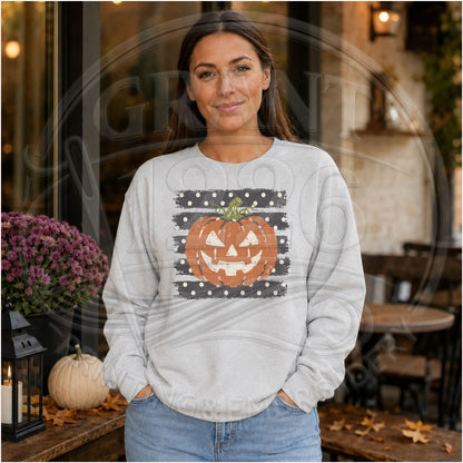 Woman wearing ash gray distressed pumpkin face Halloween crewneck sweatshirt